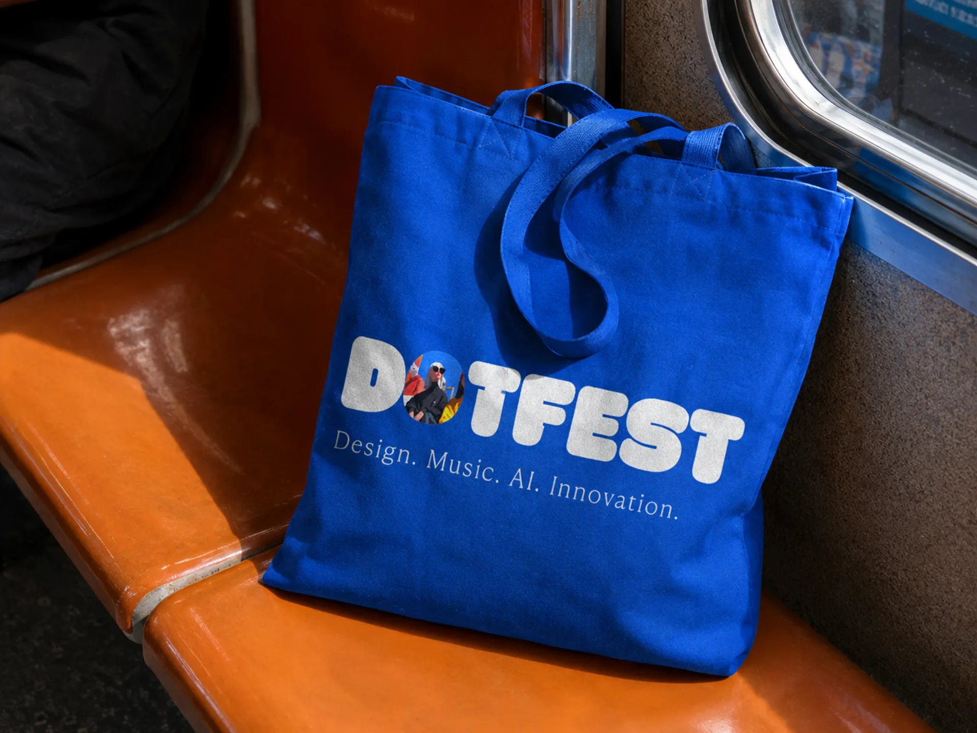 Dot Fest blue tote bag on an orange metro seat