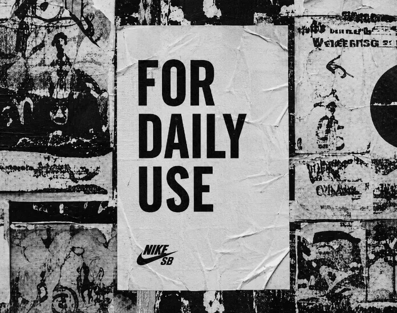 For Daily Use poster pasted on a layered city wall