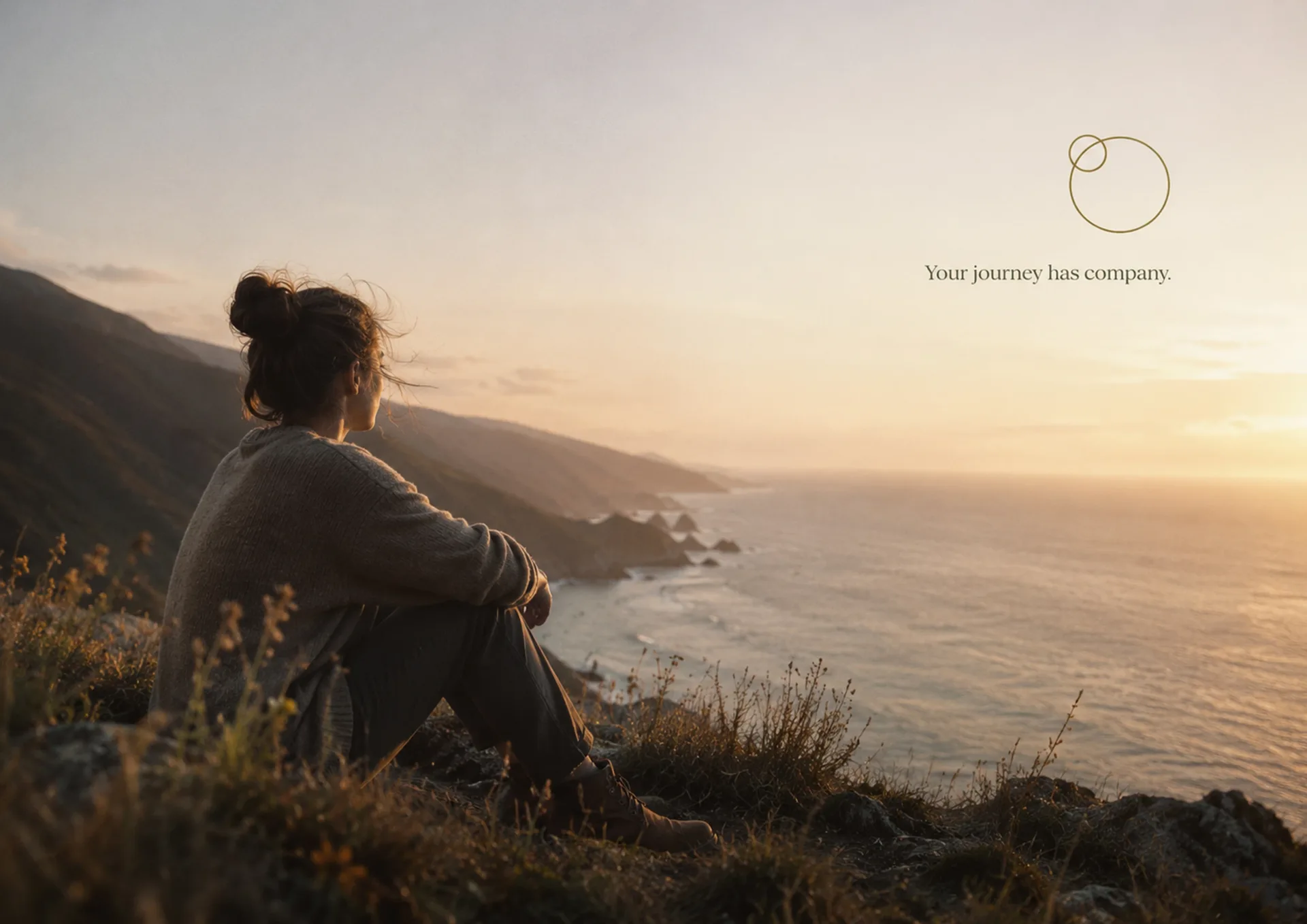 Gentle World Collective coastal hillside landscape with a seated person and the line Your journey has company