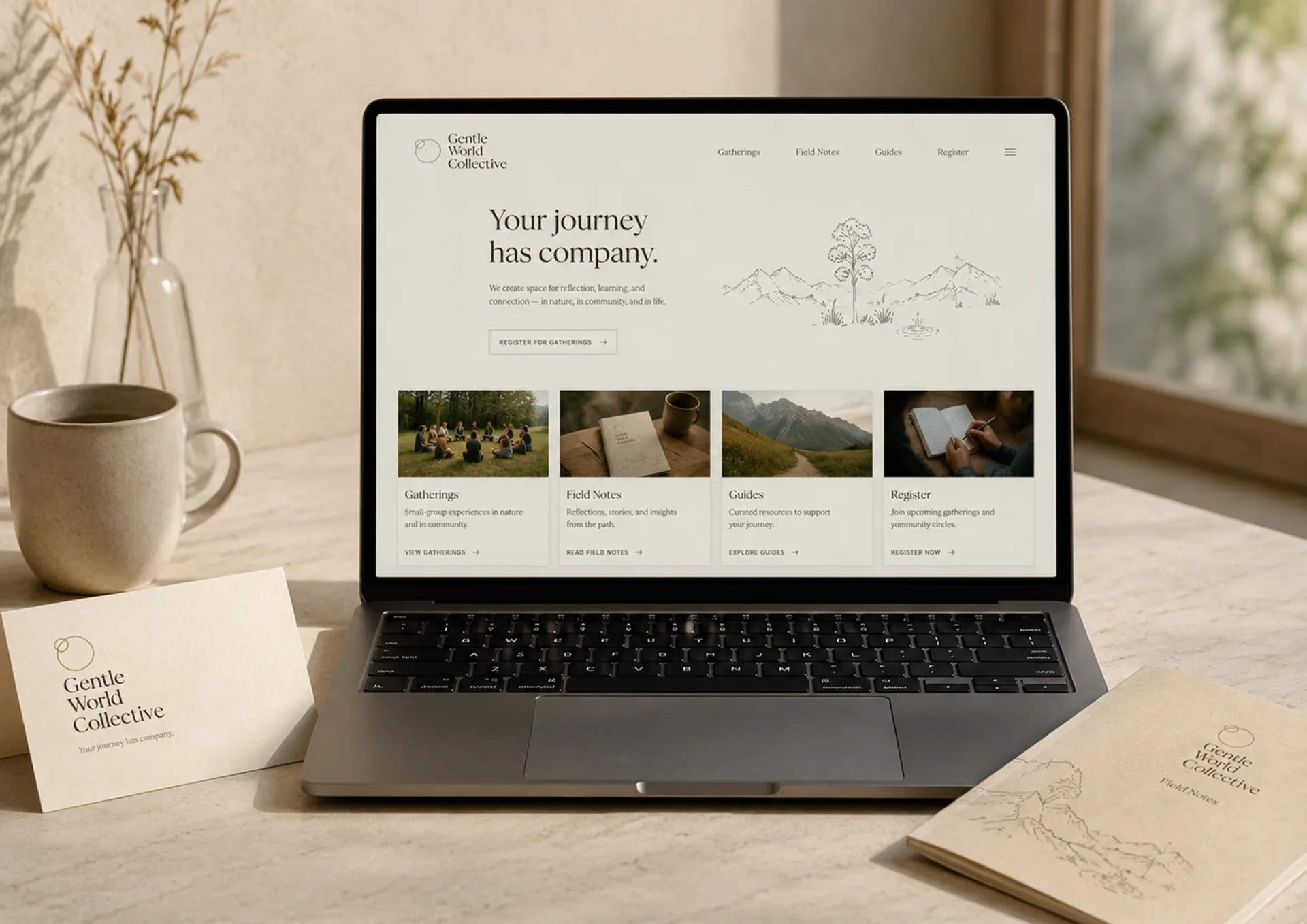 Gentle World Collective digital home page on a laptop with retreat journey cards and printed materials