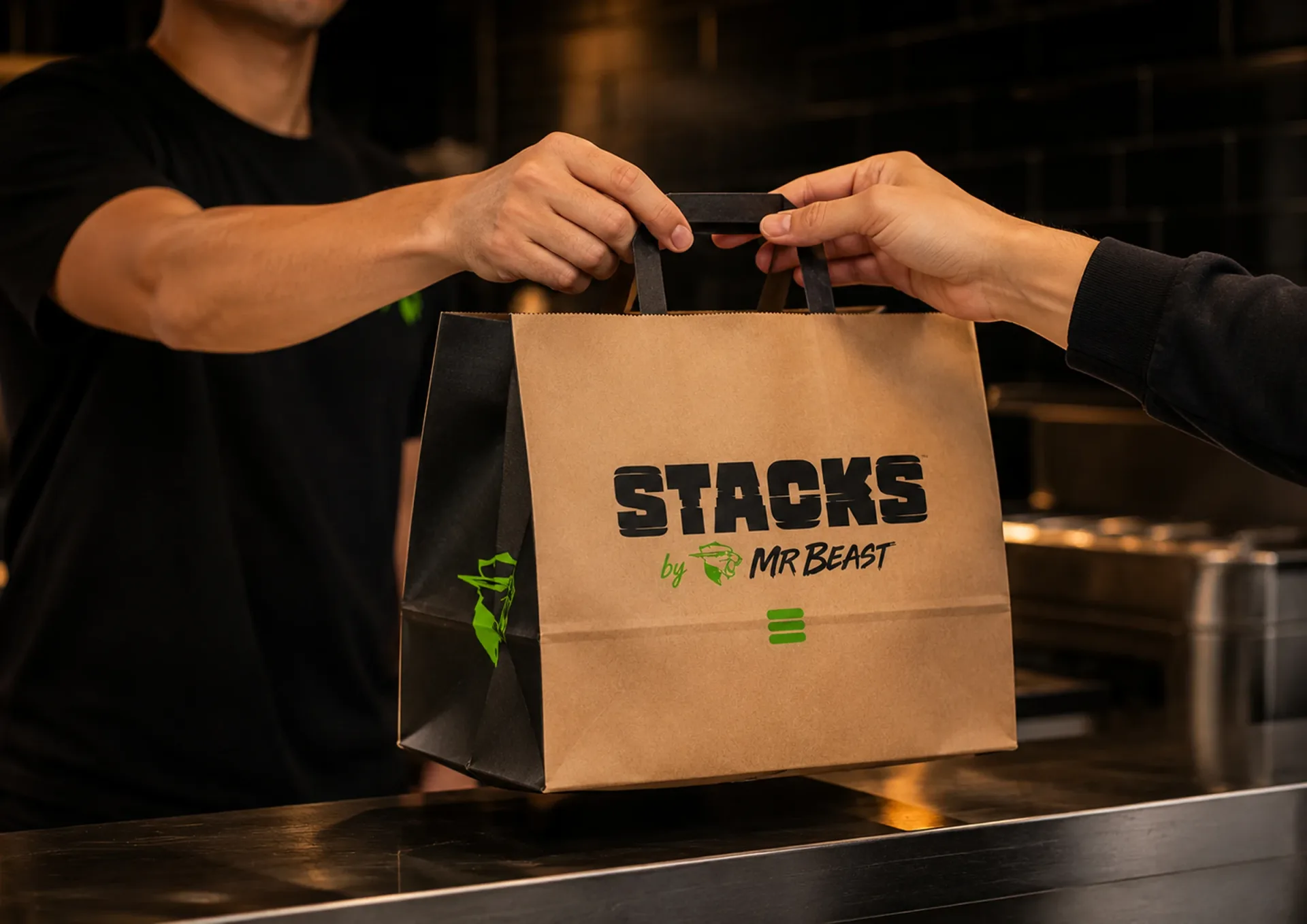 Stacks kraft takeaway bag handed across a restaurant counter